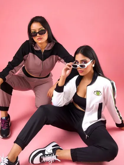 An edgy, sporty look for Raki Designs. The makeup is minimal with a slight winged liner to go with the sunglasses and tracksuits.