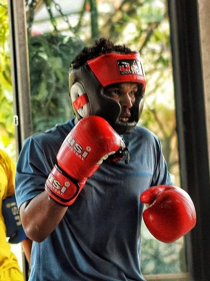 A fighter stays ready and focused during a break in sparring. The mental game is half the battle, and we train our athletes to be sharp at all times.