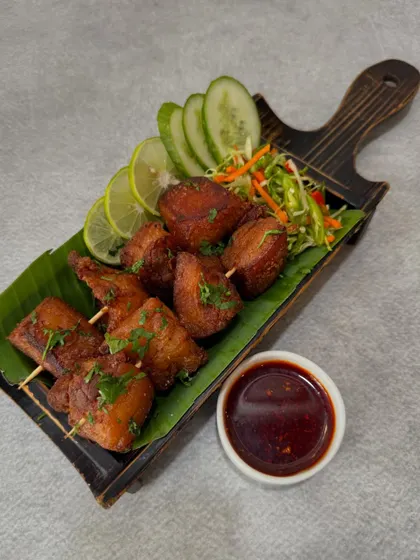 Our 'Sizzle Pork' is for those who love rich flavors. We cook tender pieces of pork in their own fat until crispy on the outside and juicy on the inside, served with a side of our signature spicy dip.