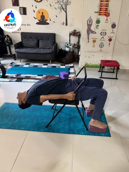 Another view of a supported backbend over a yoga chair. This restorative pose is excellent for relieving back tension and improving posture.
