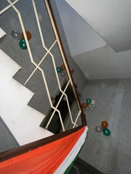 An overhead view showing the placement of fabric and balloon decorations along a multi-level staircase.