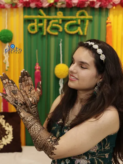 The bride admiring her beautiful Mehndi design. We capture these quiet, happy moments of anticipation.