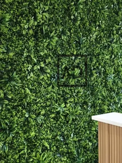 A close-up of the interior green wall, showing the detail and texture of the artificial plants used in the panel.