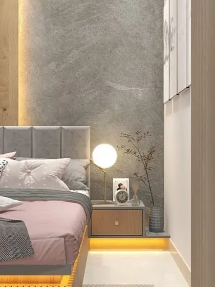 A close-up of the bedside, showing the combination of a concrete-finish accent wall and a soft, upholstered headboard. The floating nightstand and spherical lamp complete the modern look.