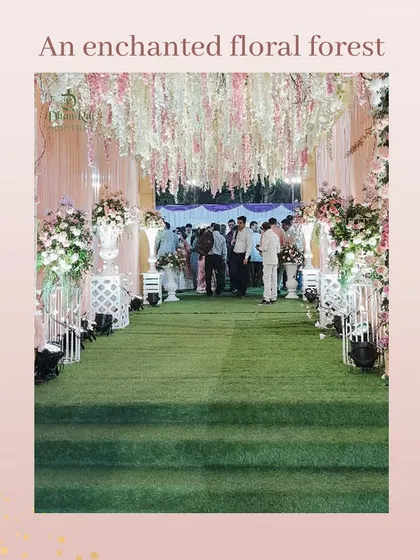 Step into an enchanted floral forest. This wedding entrance at our open ground was designed to feel like a fairytale, with a lush green path and a ceiling of hanging flowers.