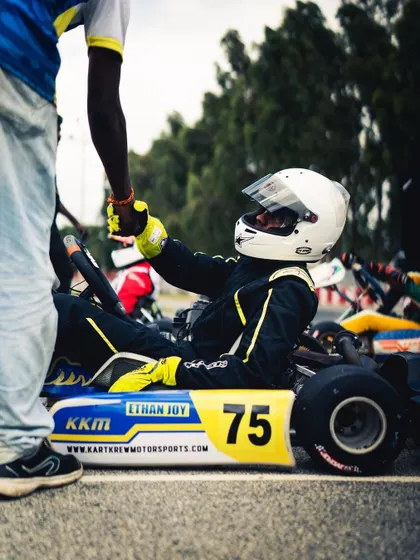 A moment of connection between a driver and his mechanic. This handshake signifies the trust and teamwork needed to overcome challenges and succeed.