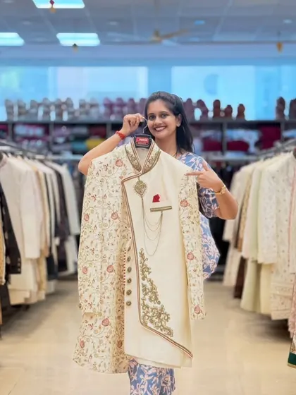 This is the kind of royal look I love providing for grooms. An off-white sherwani with an embroidered jacket layer, complete with a pocket square and chain accessory for that final touch.