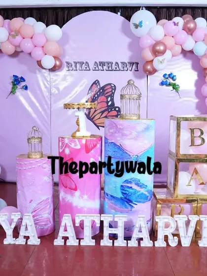 A pastel butterfly theme with a 'ONE' shelf and 'BABY' blocks, perfect for a first birthday.