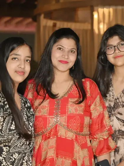 A mother and her two daughters smile for the camera. We love capturing these warm family portraits during your celebrations.