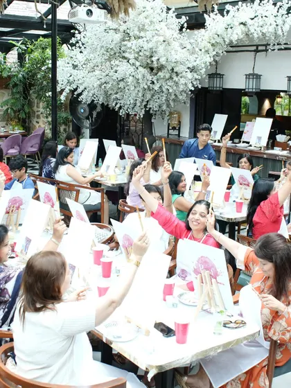 The best part of any party is the people. Here are some of the happy guests at a birthday celebration, raising their brushes in a toast to creativity and good times.
