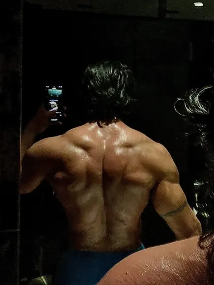 The lighting here emphasizes the shadows and contours of a well developed back. Every muscle group is trained with intention.