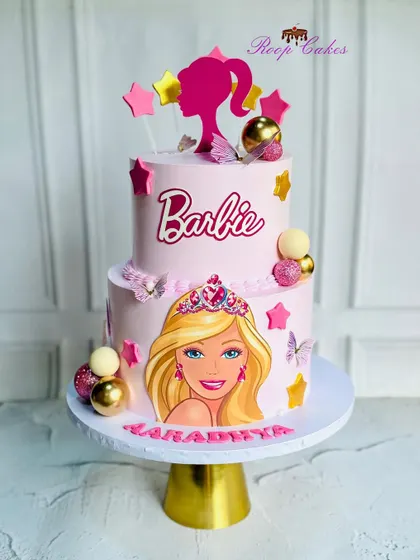 A dreamy Barbie cake fit for a little princess. This two-tier pink cake celebrates in style with sparkle, glam, and lots of sweetness.