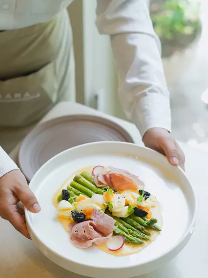 A celebration of local flavors. This dish features tender Himalayan asparagus from the Chamba region, paired with ham, crumbled egg, and a light hollandaise sauce. A European classic made with Indian produce.