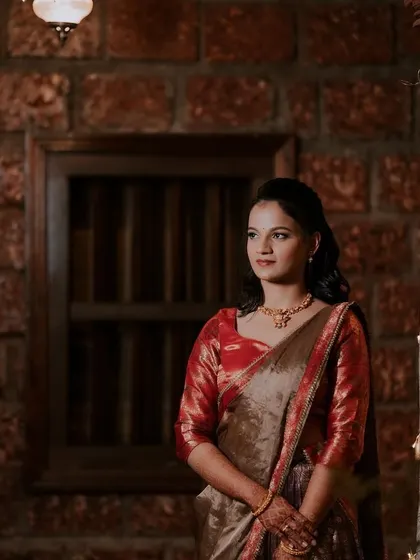 A portrait of Dhanya in her half-saree. The makeup is soft and romantic.