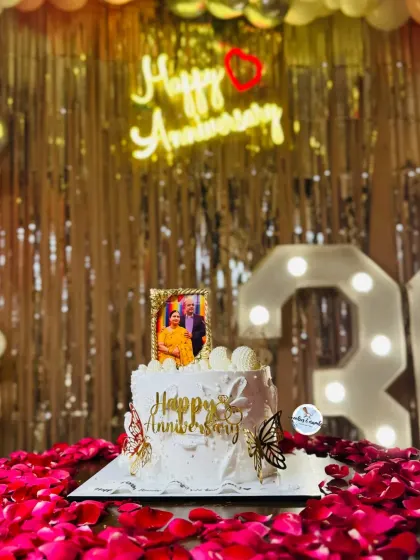 Celebrating 30 years of love with this special anniversary cake. It features an edible photo frame, golden butterflies, and delicate details, all set against a backdrop of romantic rose petals.