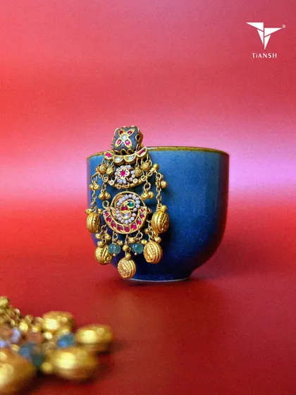 With intricate meenakari design, delicate pearls, and an opulent motif, these earrings are a celebration of craftsmanship and culture. Every gold detail is designed to add a jhanak to your style.