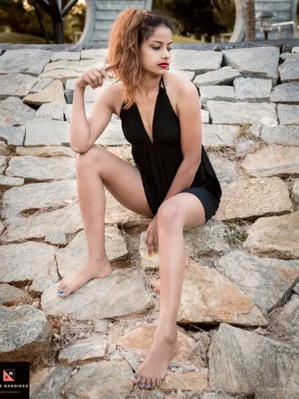 Another shot from the 'Boho' series, with the model looking thoughtfully to the side. The warm tones and rocky texture of the environment enhance the wild and free mood.