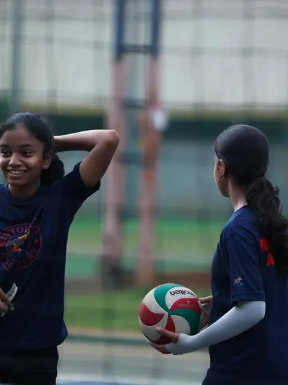 A quick break and a smile between drills. The friendships formed on this court are just as important as the skills learned.