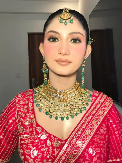A straight-on portrait of Khushi, showcasing the clean lines of her makeup and the beautiful symmetry of her look.