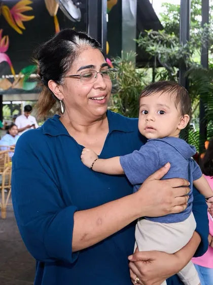A grandmother lovingly holding her baby grandchild. We welcome guests of all ages.
