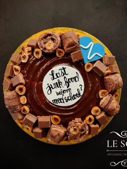 For a celebration that's a little different, I created this Giant Doughnut Cake. It's a 7-inch baked doughnut loaded with chocolate, hazelnuts, and custom messages, perfect for any party.