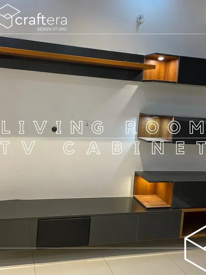 This living room TV cabinet features a minimalist design with a mix of open and closed storage, highlighted by built-in accent lighting.