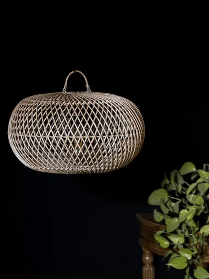 The unlit version of the flattened globe pendant. Its organic, slightly imperfect shape is a reminder of its handmade journey from natural material to finished light fixture.