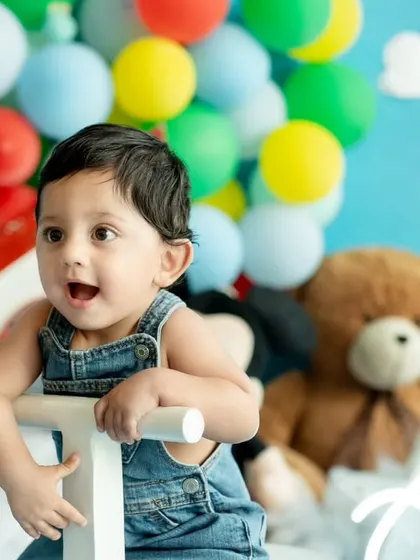 A close-up shot capturing the wonder and excitement in this little one's eyes during his 'Up' themed first birthday photoshoot.