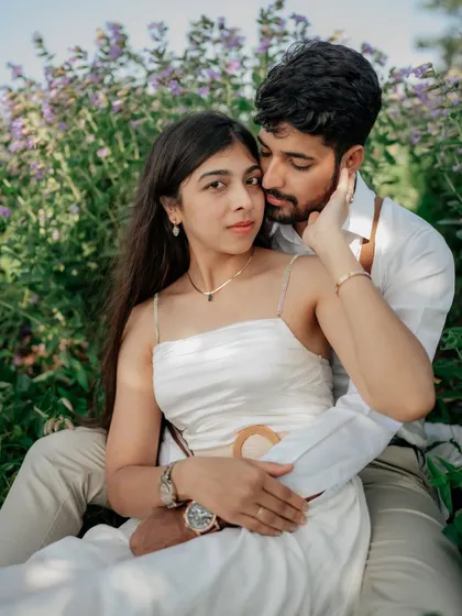 An intimate portrait in a field of purple flowers. The way he holds her close creates a feeling of safety and love.