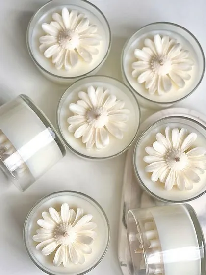 Monochromatic daisy candles in simple glass jars. These are perfect for any occasion and are a budget-friendly way to make your space feel special.