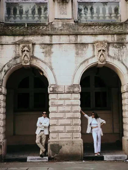 Using the architectural details of the building to frame the couple. This wide shot has a powerful, symmetrical composition.