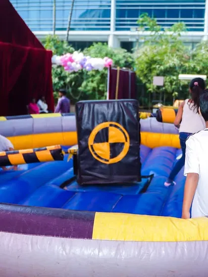 An inflatable wipeout-style game where kids have to jump and duck to avoid a rotating arm, testing their agility and timing.