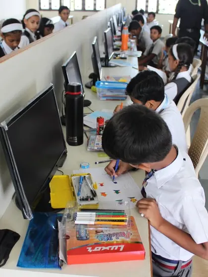 Young participants collaborating and competing in the computer lab during the 2023 Olympiad.