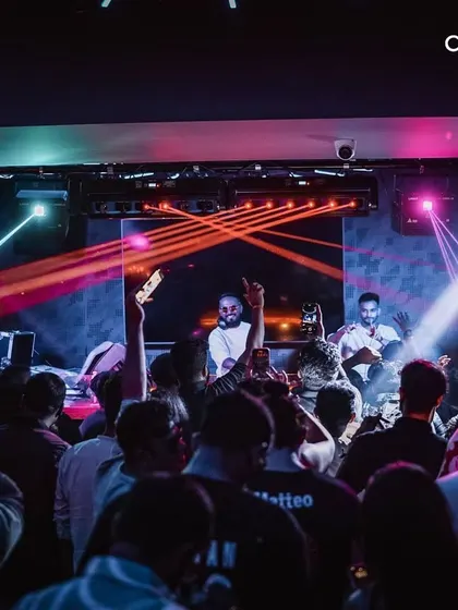 The energy of a packed club night, with lights cutting through the crowd. My goal is to create a completely immersive audio-visual experience on the dance floor.