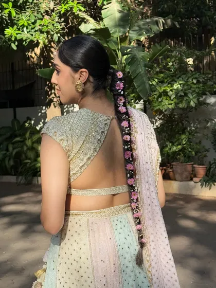 A stunning close-up of a traditional floral braid. I wove fresh pink flowers through the length of the braid for a beautiful and fragrant Haldi hairstyle.
