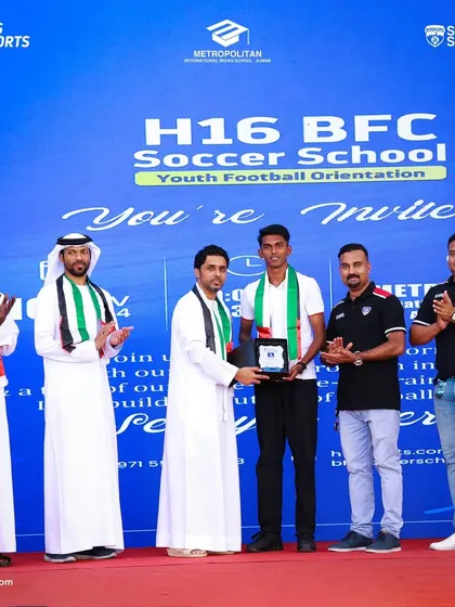 A young BFC player is honored on stage during the H16 BFC Soccer School launch in the UAE.