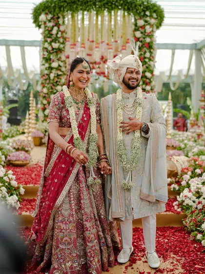 A beautiful varmala moment where the couple is surrounded by stunning floral decor. I ensure every angle is picturesque for these once-in-a-lifetime shots.
