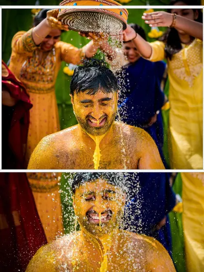 The groom gets a refreshing and playful shower during his Haldi ceremony. We use fast shutter speeds to freeze the water droplets for a dynamic and fun photograph.
