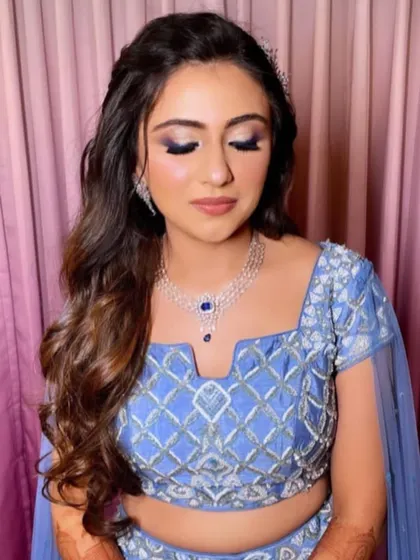 A close-up of the bride's makeup and hair, showing the soft, flowing waves.