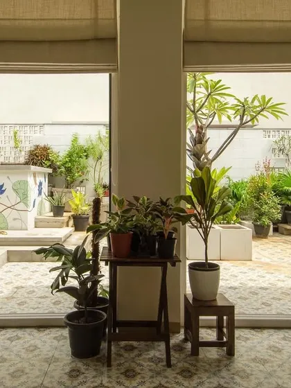 Looking out from the living space into the terrace garden of a renovated urban home. Replacing solid walls with large sliding glass doors was key to creating this seamless connection to the outdoors.