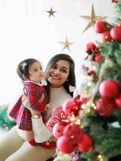 The pure sweetness and joy of a mother and daughter bond, captured during a festive Christmas mini-session. Her little girl is looking up at the tree with so much wonder.