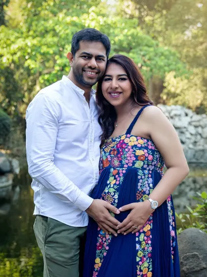 A classic pose with both parents making a heart shape with their hands on the bump. It's a sweet and symbolic gesture that I love to capture.