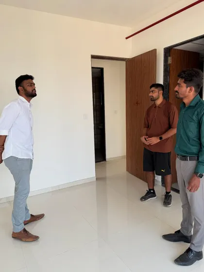 A full view of the initial client meeting in an empty apartment, setting the stage for the transformation to come.