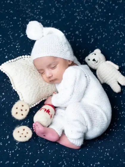 The same sleepy boy setup, now with adorable milk and cookie props.