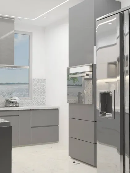 A modern kitchen with high-gloss grey cabinets and a side-by-side refrigerator. The reflective surfaces help to make the space feel larger and brighter.