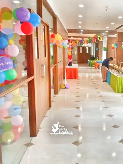 A look at the party space and buffet area for the art-themed birthday, showing how the colorful decor was integrated throughout the entire venue for a cohesive experience.