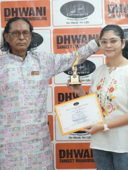 An adult student receives her award from our senior guru.