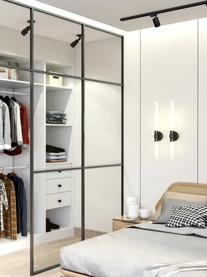 For this North Bengaluru client, I designed a minimal bedroom with warm wood tones and crisp whites. The glass-paneled wardrobe and modern wall sconces create a clean, tranquil, and balanced look.