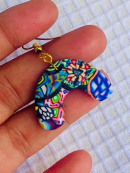 This arch-shaped earring showcases a collage of different polymer clay patterns I've created. It's a true testament to the versatility of this amazing material.