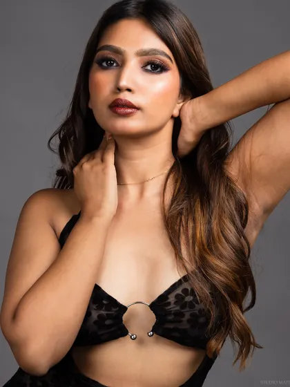 A direct and engaging portrait of the model in the same sheer dress.